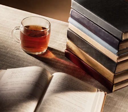 Cup of tea and books on the tableの写真素材