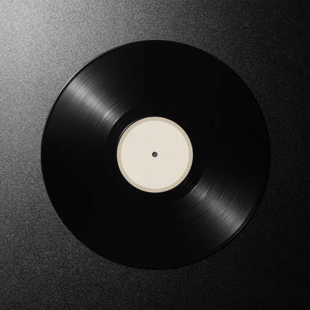 Black vinyl record on a dark backgroundの写真素材