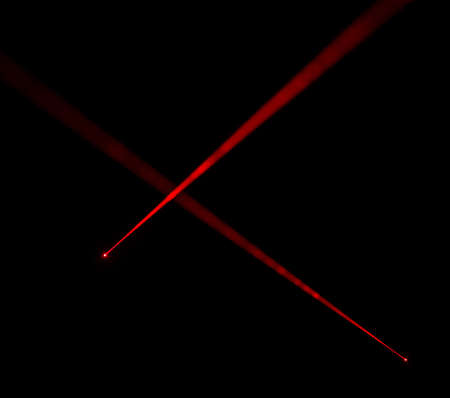 Red laser beams on black backgroundの写真素材