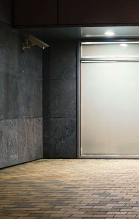 Modern office building exterior fragment with surveillance camera on the wallの写真素材