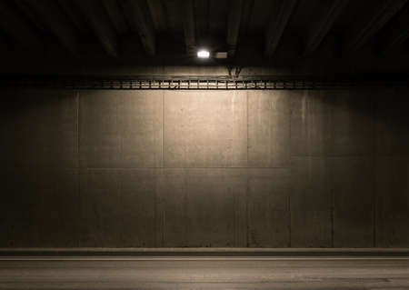 Tunnel road area with spotlight on the wall