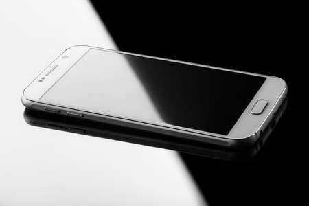 Smart phone on the glossy surface background