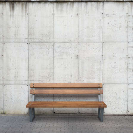 Bench against concrete wallの写真素材