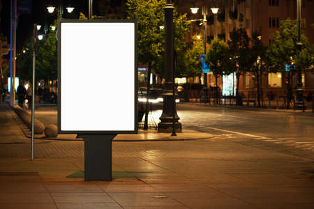 Blank advertising billboard in the city at night.の写真素材