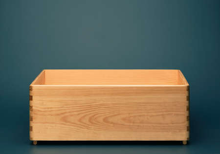 Empty wooden box on blue background