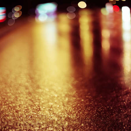 Abstract dark blurry urban background. Wet road.の写真素材