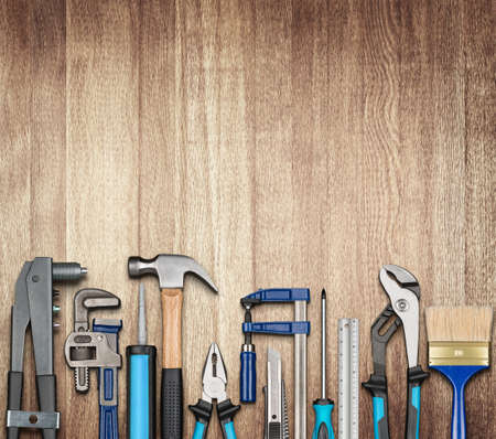 Various carpentry, repairing, DIY tools on wooden background