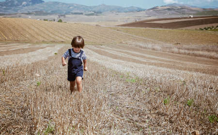Beautiful little boy in rural landscapes