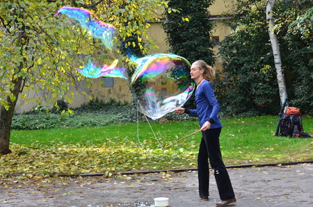 PRAGUE, CZECH REPUBLIC - OCT  13: Street performer blowing huge soap bubbles in Prague, Czech Republic on October 13, 2013.のeditorial素材