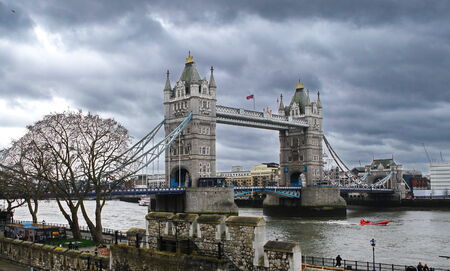 Dramatic view of the London Tower Bridge with ominous skyの写真素材