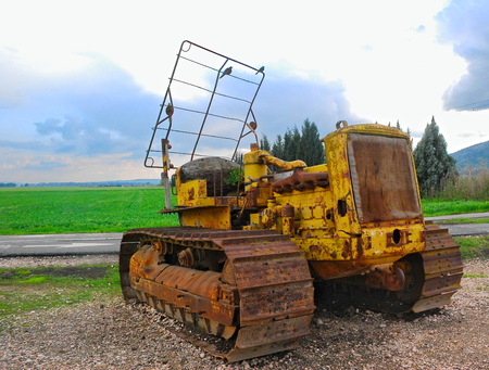 GOLAN HEIGHTS, ISRAEL - MARCH 12, 2011: Birds resting on a rusty old tank-like decommissioned farm machinery in the Golan Heights, Israelのeditorial素材
