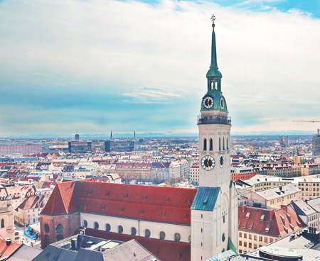 Rooftop view of the Munich cityscape with clock tower, church, and spiresの写真素材