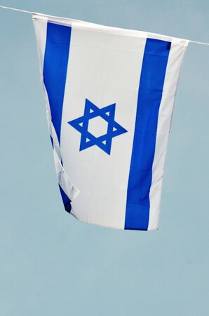 Israel flag in white and blue showing the Star of David hanging proudly for Israel's Independence Day (Yom Haatzmaut)の写真素材