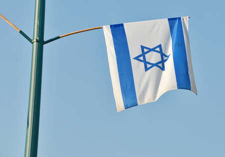 Israel flag in white and blue showing the Star of David hanging proudly for Israel's Independence Day (Yom Haatzmaut)の写真素材