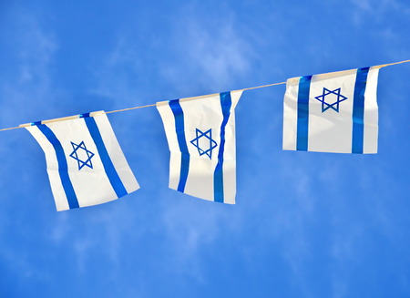 Israel flags in a chain in white and blue showing the Star of David hanging proudly for Israel's...