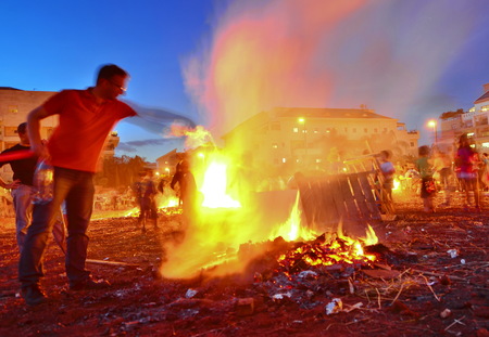 TEL AVIV, ISRAEL - MAY 18, 2014: Secular Israeli Kids having fun at Lag BaOmer with bonfires and food - motion, long exposureのeditorial素材