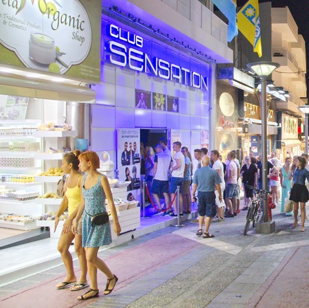 HERSONISSOS, GREECE - JULY 21, 2014: Young people touring and shopping the action-packed streets of Crete, the Greek Mediterranean Island on a warm summer nightのeditorial素材