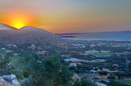 Sunset on the Malia Hersonissos harbor near Heraklion, Crete, Greece with the mountains touching the sea  HDR image の写真素材