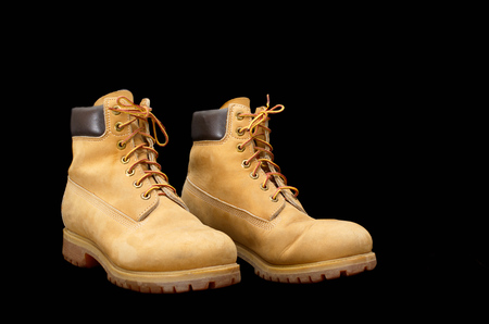 Authentic pair of 8 inch Yellow Work Boots isolated on blackの写真素材