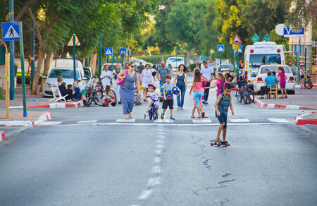 TEL AVIV - OCT. 4, 2014: People walking and riding in the streets on Yom Kippur (Day of Atonement) in Tel Aviv.  There is little car travel and Israelis freely walk, bike and skate on the streets.のeditorial素材