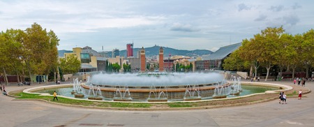 BARCELONA - OCT. 14, 2014 - The Magic Fountain (Font magica) in front of the The Venetian Towers and Placa d'Espanya (Plaza de Espana) in Montjuic, Barcelona, Spainのeditorial素材