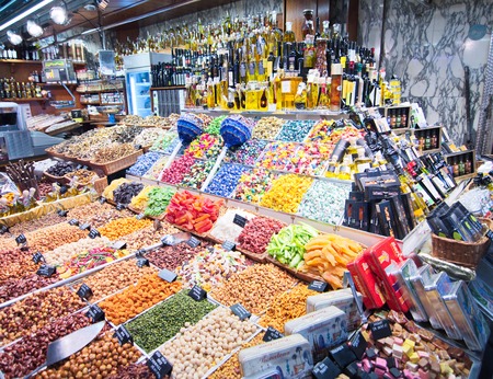 BARCELONA, SPAIN - OCT 14, 2014: Colorful candy and drinks in the famous Barcelona La Boqueria Market (Mercat de Sant Josep de la Boqueria) in Catalonia, Spainのeditorial素材