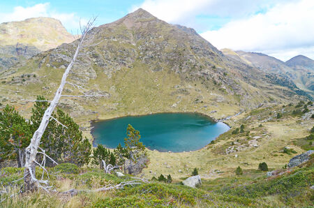 Estany de Mes Amunt - one of the three lakes of Tristaina (Estanys de Tristaina) in Andorra near the Ordino-Arcalis ski resort in the springの写真素材