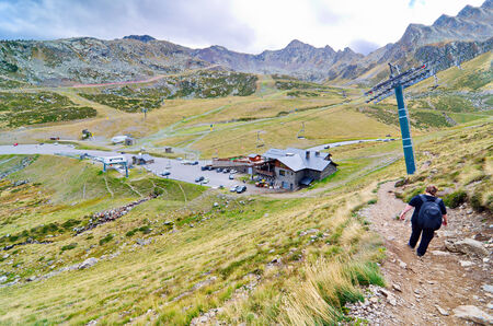 People hiking to the three lakes of Tristaina (Estanys de Tristaina) in Andorra near the Ordino-Arcalis ski resort in the springの写真素材