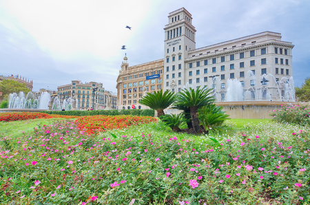 BARCELONA, OCT 14, 2014: Colorful flowers, fountain, and architecture in  in Placa de Catalunya (Catalonia Plaza), Barcelona near La Ramblaのeditorial素材