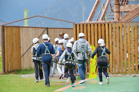 NATURLANDIA, ANDORRA - OCT 10, 2014: A group of people  walking together preparing to enter a challenging rope course sky trail in the Andorra Pyrenees Mountainsのeditorial素材