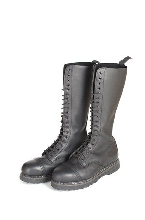 New tall lace-up knee-high black leather boots featuring 20 eyelets and steel-toes.  Fashion combat work boots worn by both men and women.の写真素材