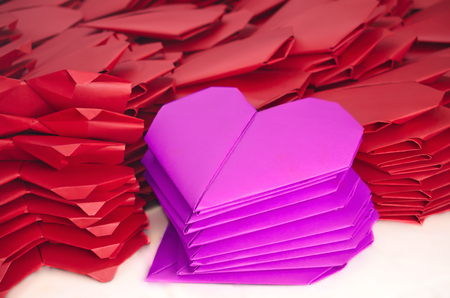 Lots of pink and red paper origami hearts for Valentine's Day symbolizing loveの写真素材