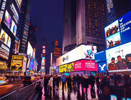 NEW YORK, MARCH 14, 2015: Times Square at night - HDR featuring busy Broadway with animated signs for the Lion King and other shows.  Theater District is a symbol of New York and the United States.