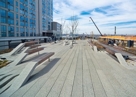 NEW YORK - MARCH 11, 2015: People walking the Manhattan New York High Line - a historic raised railroad track turned into a unique, modern public park winding between buildings and above the streetsのeditorial素材