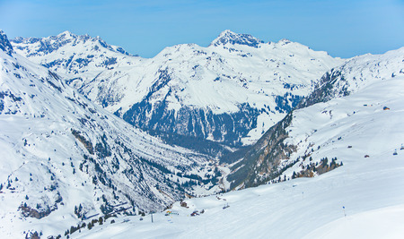 View of the pistes, ski trails, and mountains of the Lech Zurs ski resort, part of the Arlberg  ski area, from a mountainside restaurant.の写真素材