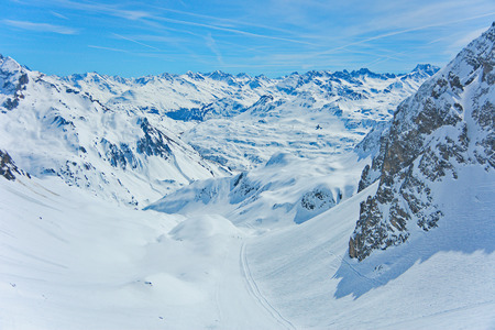 View of the pistes, ski trails, and mountains of the Lech Zurs ski resort, part of the Arlberg  ski area, from a mountainside restaurant.の写真素材