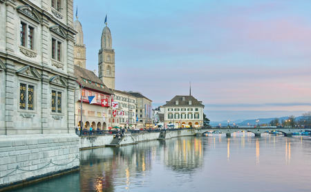 ZURICH, SWITZERLAND - APRIL 13, 2015: Views of the Zurich, Switzerland Limmat River and historic architecture at the golden hour after the Sechselauten (Sachsiluute) - Zurich Spring Festivalのeditorial素材