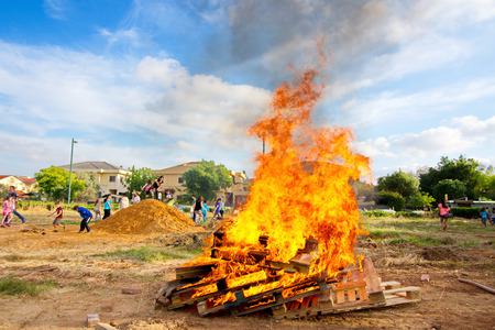 TEL AVIV, ISRAEL - MAY 3, 2015: Elementary school kids participating in festive Lag Baomer bonfires...