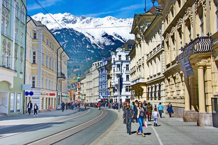 INNSBRUCK, AUSTRIA - APRIL 9, 2015: People enjoying one of the first spring days in the old alpine town of Innsbruck with views of snow capped mountains and historic architecture.のeditorial素材