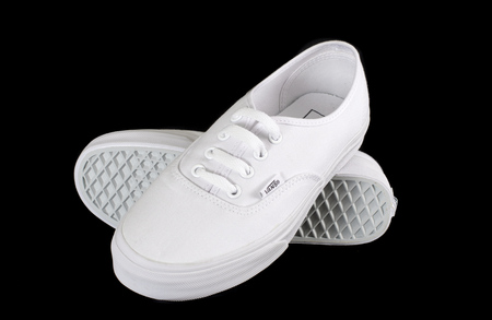 NEW YORK - AUGUST 8, 2015: White Vans (Off the Wall) sneakers isolated on blackのeditorial素材