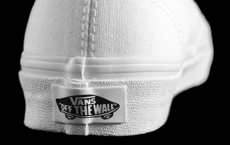 NEW YORK - AUGUST 8, 2015: White Vans (Off the Wall) sneaker isolated on blackのeditorial素材