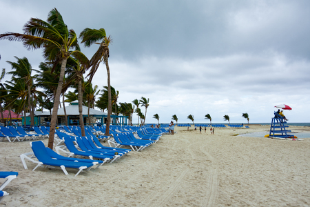 COCO CAY, BAHAMAS - OCT 16, 2016: A lifeguard on a cloudy and windy day on the beach of the tropical paradise private island of Coco Cay in the Bahamasのeditorial素材