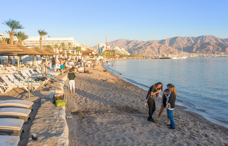 EILAT, ISRAEL - DEC. 29, 2016: People spending their Christmas and New Year vacation bathing on the...