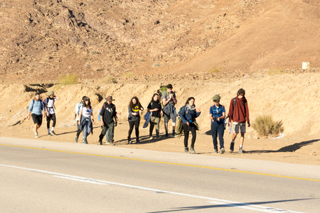 NEGEV, ISRAEL - DEC. 29, 2017: A group of young tourist men and women touring the Negev Desert in the south of Israelのeditorial素材