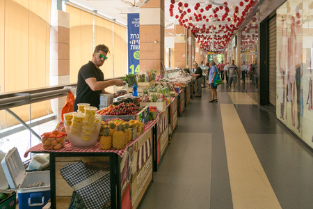 TEL AVIV - MAY 26,  2017: Modern open air shopping mall in Israel.  Vegetable stand in a posh Israel open air shopping mall featuring weekend market stands.のeditorial素材