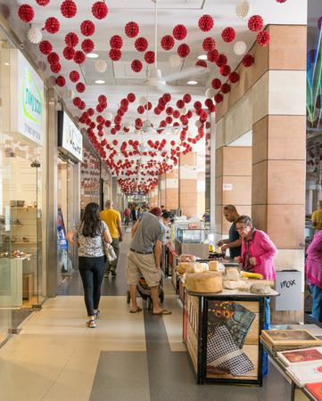 TEL AVIV - MAY 26,  2017: Modern open air shopping mall in Israel.  People in a posh Israel open air shopping mall featuring weekend market stands.のeditorial素材