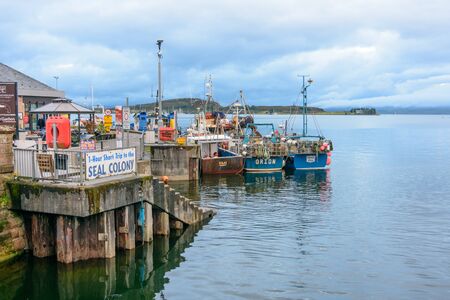 OBAN, SCOTLAND - AUG. 25, 2017: Blue hour on the Oban Bay, a small city attracting many tourists on...