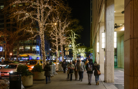 NEW YORK CITY - NOV. 24, 2017: People strolling at night near Columbus Circle, Manhattan with Christmas lights on the trees  - blurred motion long exposureのeditorial素材