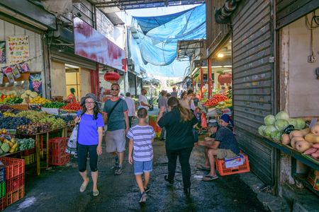 TEL AVIV - OCT. 11, 2017: Sellers, customers, and color at the busy Carmel Market in Tel Aviv, Israel on the eve of Sukkotのeditorial素材
