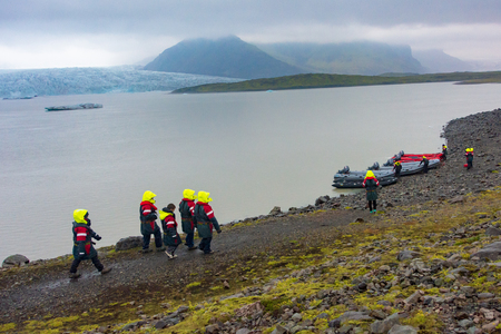 VATNAJOKULL, ICELAND - JULY 28, 201: Two families getting ready to sail on a Blue Ice Zodiac boat tour on the Fjallsarlon Glacial Lagoon on an arm of the huge Vatnajokull glacier in South Icelandのeditorial素材